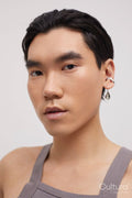 Studio portrait of handsome man with ear piercing