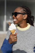 Smiling young woman eating ice cream