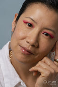 Portrait of mid adult woman wearing pink eyeshadow