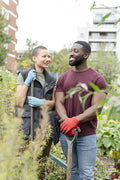 Portrait of smiling couple standing in urban garden