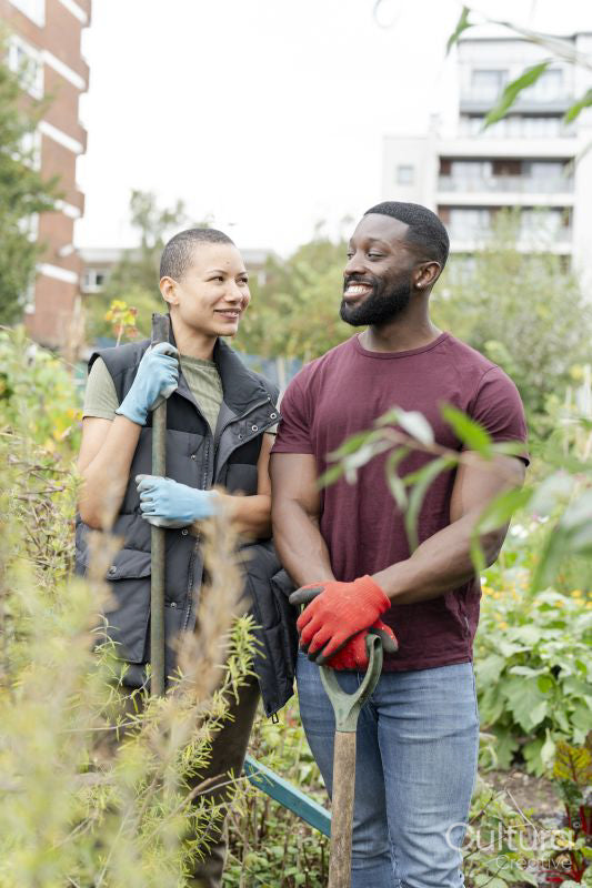 Portrait of smiling couple standing in urban garden