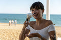 Smiling woman holding melting ice-cream