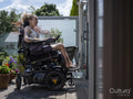 Woman in electric wheelchair relaxing on deck