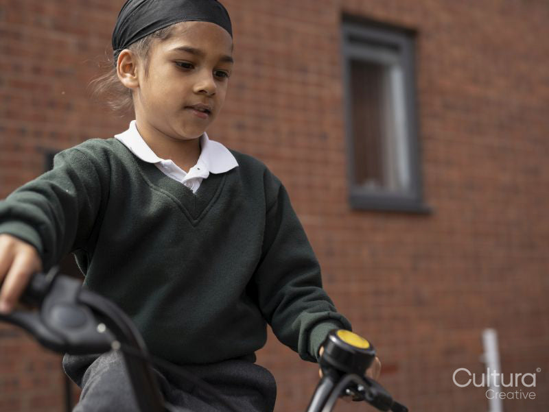 Boy in school uniform riding bicycle