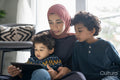 Mother and sons using digital tablet at home