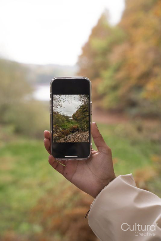 Woman photographing landscape while hiking