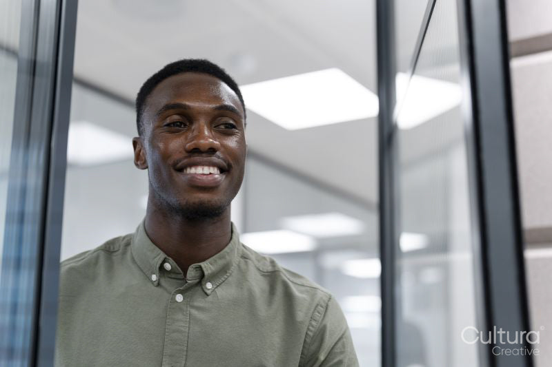 Happy young man in office