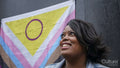 Portrait of mature woman in front of pride flag