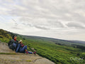 Female hikers sitting on rocks and looking at landscape