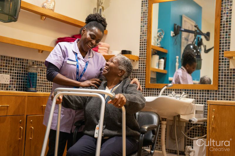 Nurse helping woman with mobility walker in hair salon