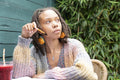 Young woman writing diary in garden