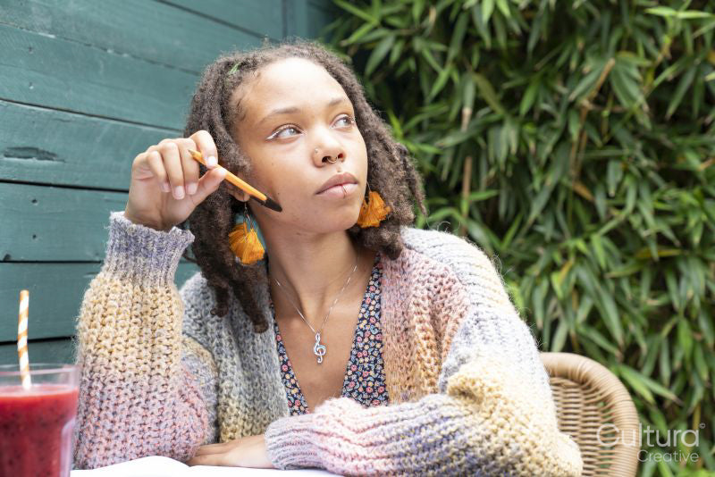 Young woman writing diary in garden