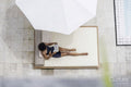 Overhead view of woman relaxing on poolside
