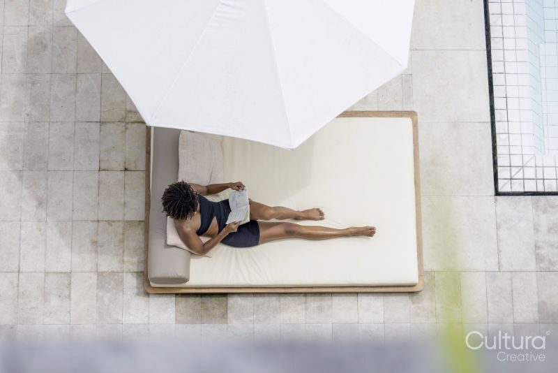 Overhead view of woman relaxing on poolside