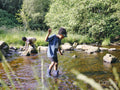 Children playing in shallow creek