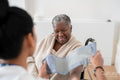 Female doctor measuring senior patients blood pressure