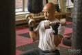Mature man lifting dumbbells in gym
