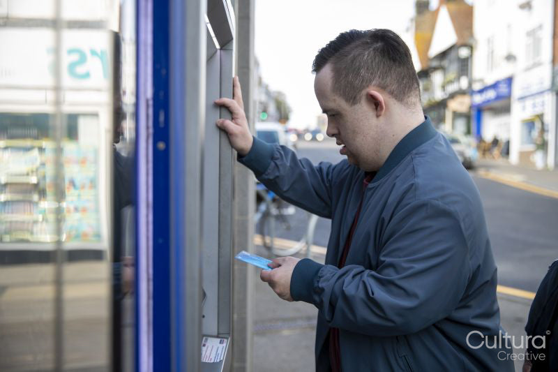 Man using cash machine in street