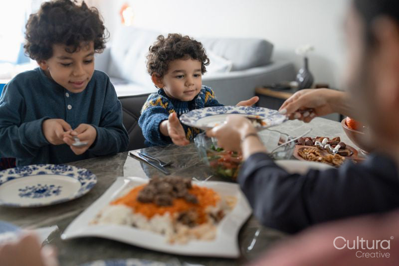 Family with sons eating meal at home