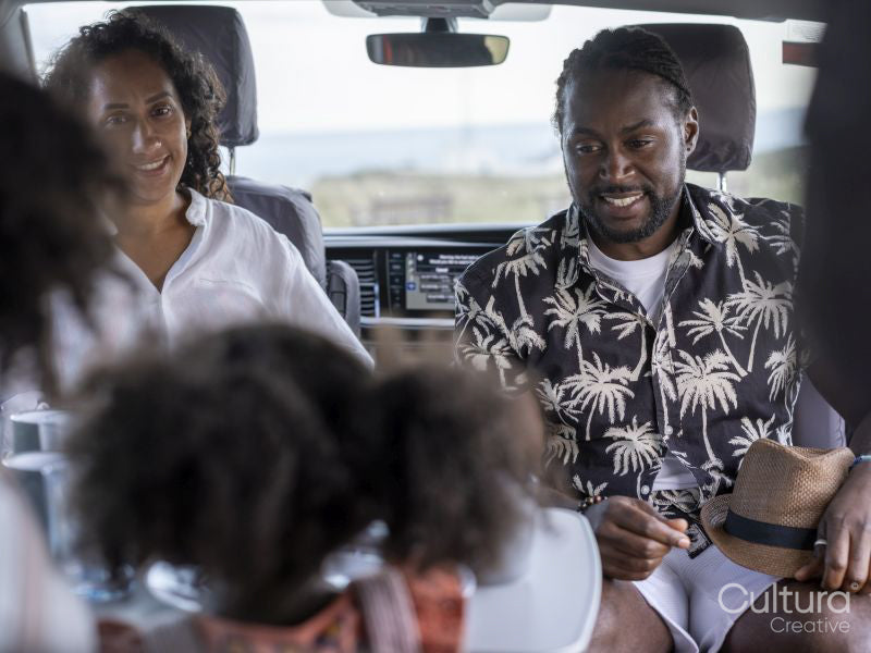 Family with daughter camping in camper van