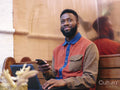 Smiling businessman using smart phone and laptop