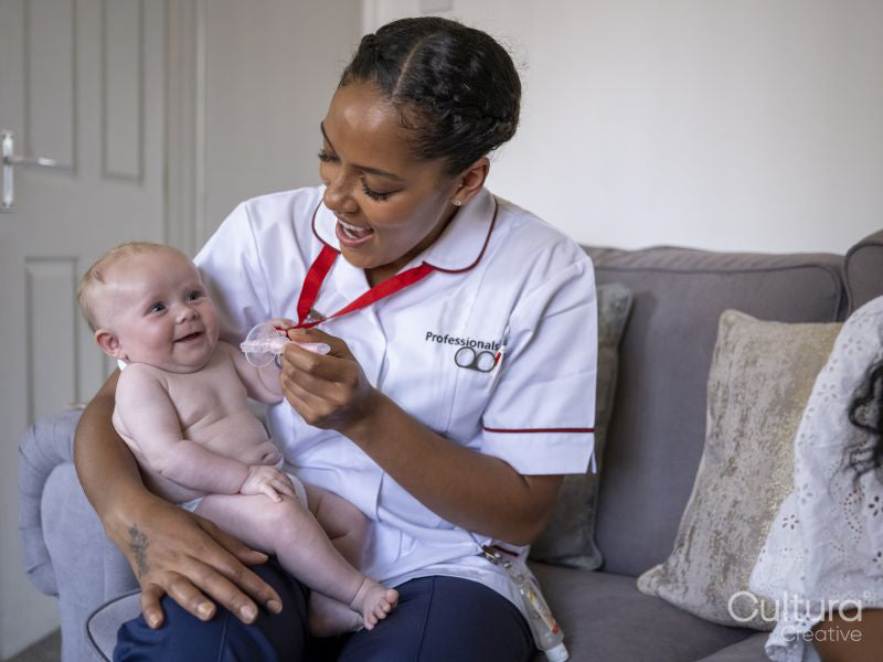 Nurse taking care of baby girl