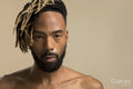 Studio portrait of young man with dreadlocks