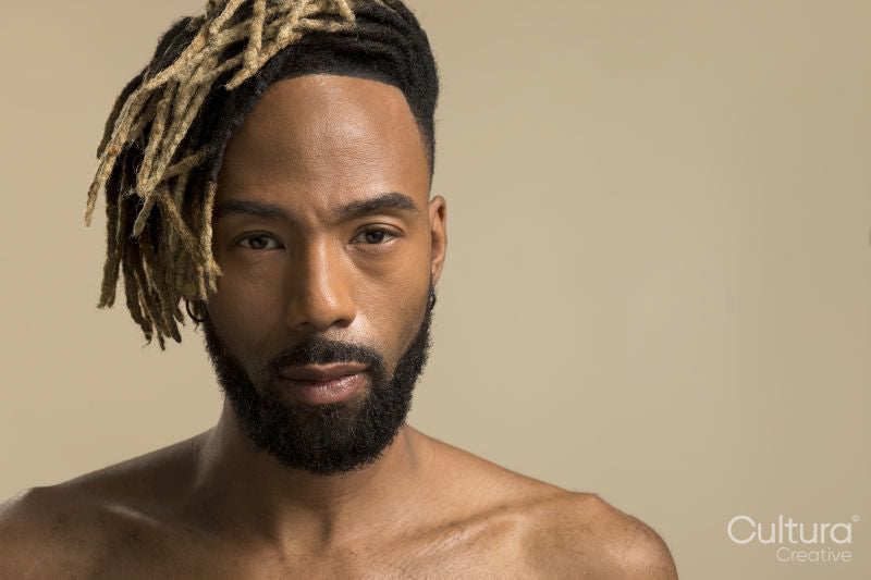 Studio portrait of young man with dreadlocks
