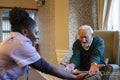 Senior man exercising with nurse in nursing home