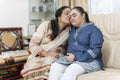 Portrait of grandmother and granddaughter in living room