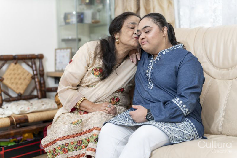 Portrait of grandmother and granddaughter in living room