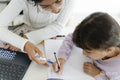 Girl helping little sister doing homework