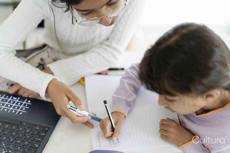 Girl helping little sister doing homework