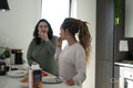 Two women preparing meal in kitchen