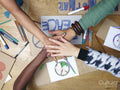People stacking hands over protest signs