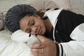 Girl text messaging on mobile phone while lying on bed