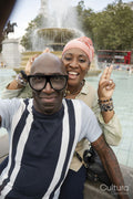 Happy mature couple posing next to fountain in Trafalgar Square