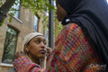 Young woman adjusting friends hijab
