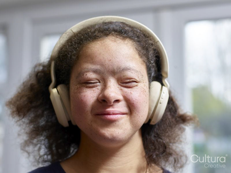 Girl with Down syndrome wearing headphones