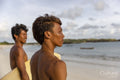 Indonesia, Lombok, Side view of surfers looking at sea from beach