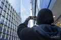 Young woman using phone to take pictures in city