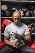 Mature man wrapping hands for boxing match