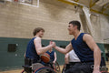 Men in wheelchairs shaking hands after match