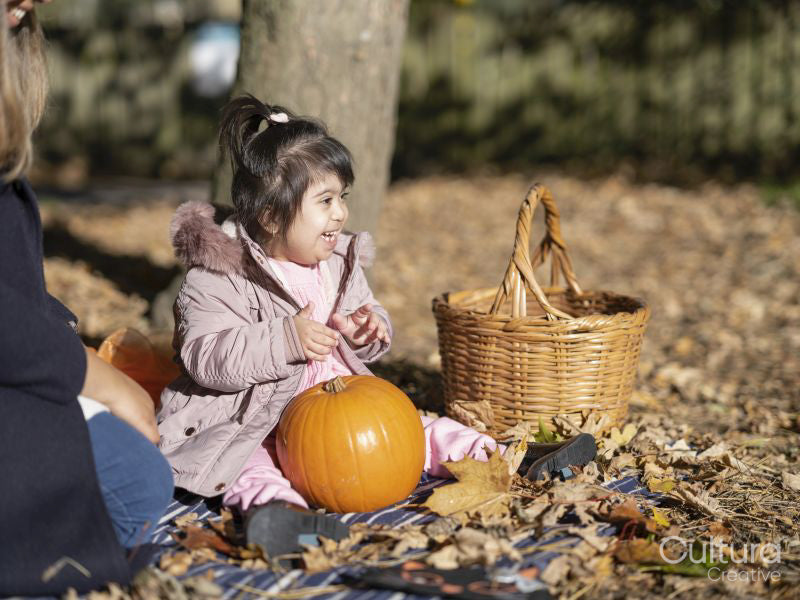 Mother and daughter with Down syndrome playing in park
