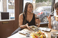 Smiling friends enjoying Me,ican food at restaurant table