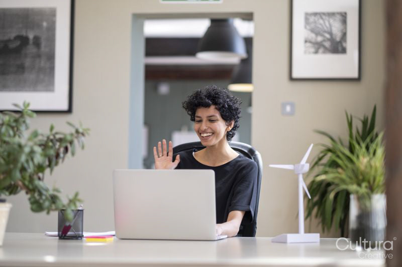 Young engineer having video call on laptop in office