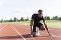Athlete preparing to sprint at running track