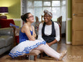 Smiling mother and daughter with Down syndrome in ballerina costume