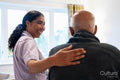 Nurse visiting senior man in his room at nursing home