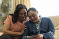Woman with down syndrome daughter using smart phone at home